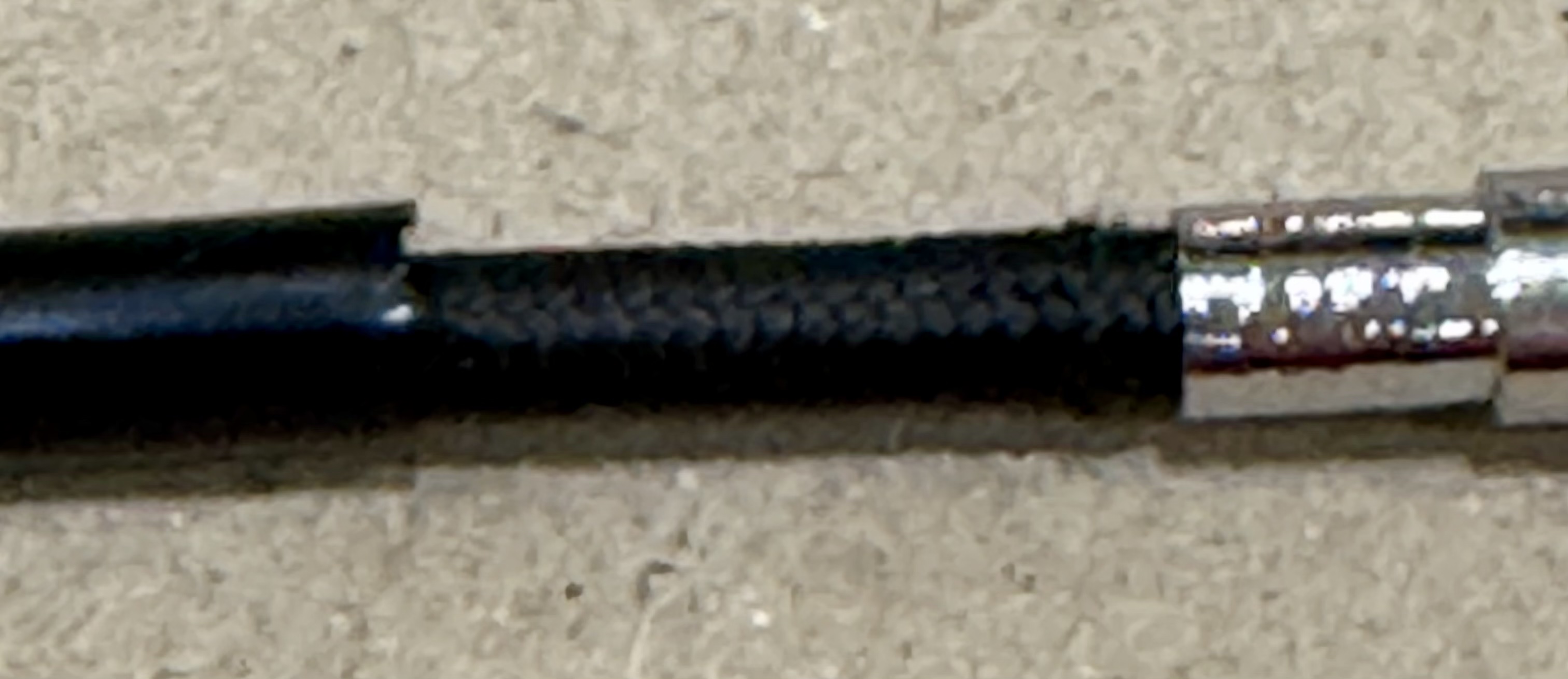 Generic cable with part of PVC removed showing cloth inner.